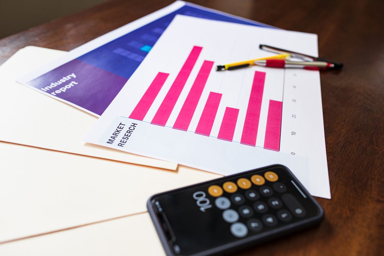services-img Illustrative market research chart and calculator on wooden desk for business analysis.